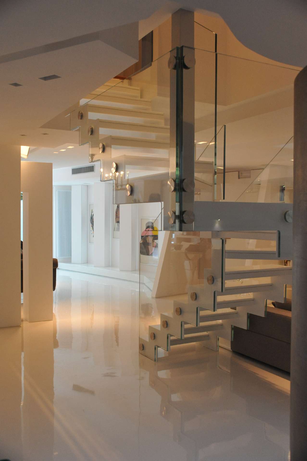 White Corian staircase with a glass balustrade