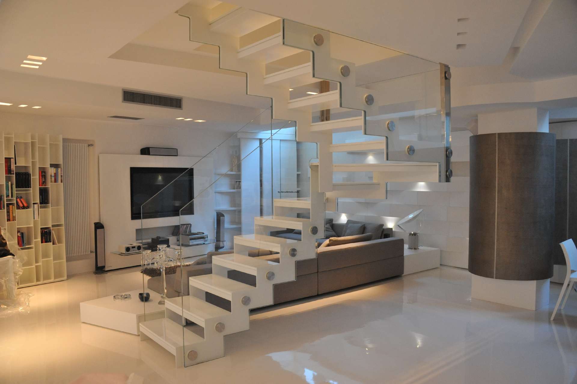 The white staircase in the open-plan living room