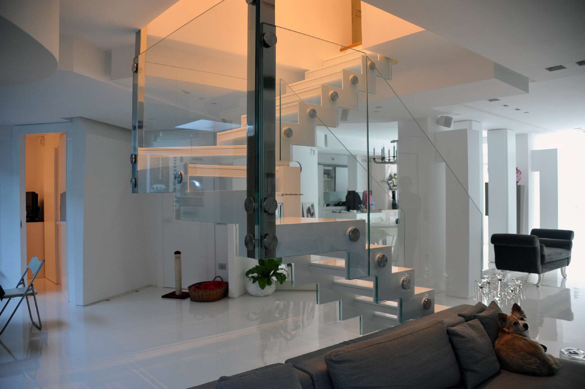 White Corian staircase with a glass balustrade made by Arco Arredo