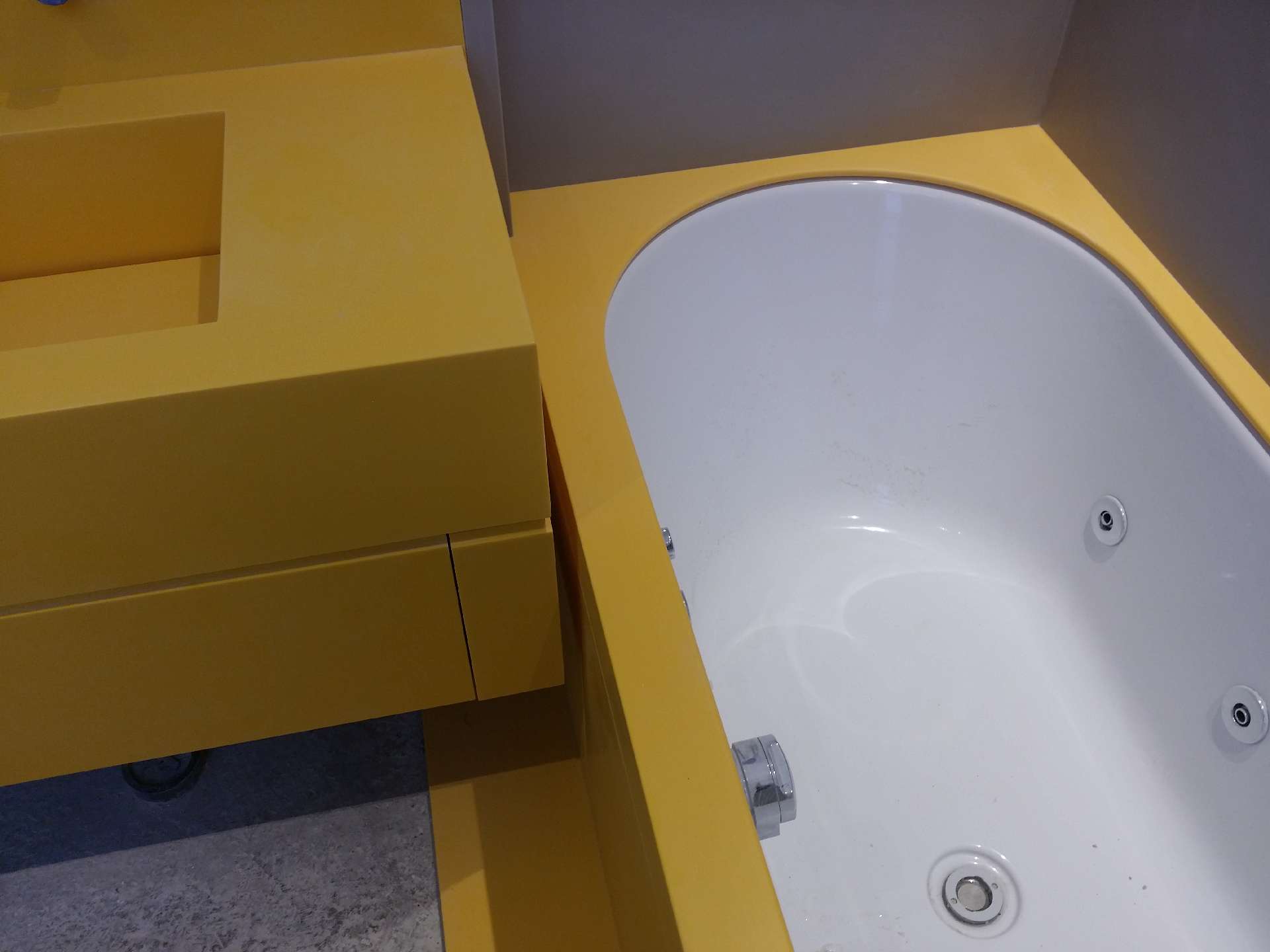 Two bathrooms in yellow Corian