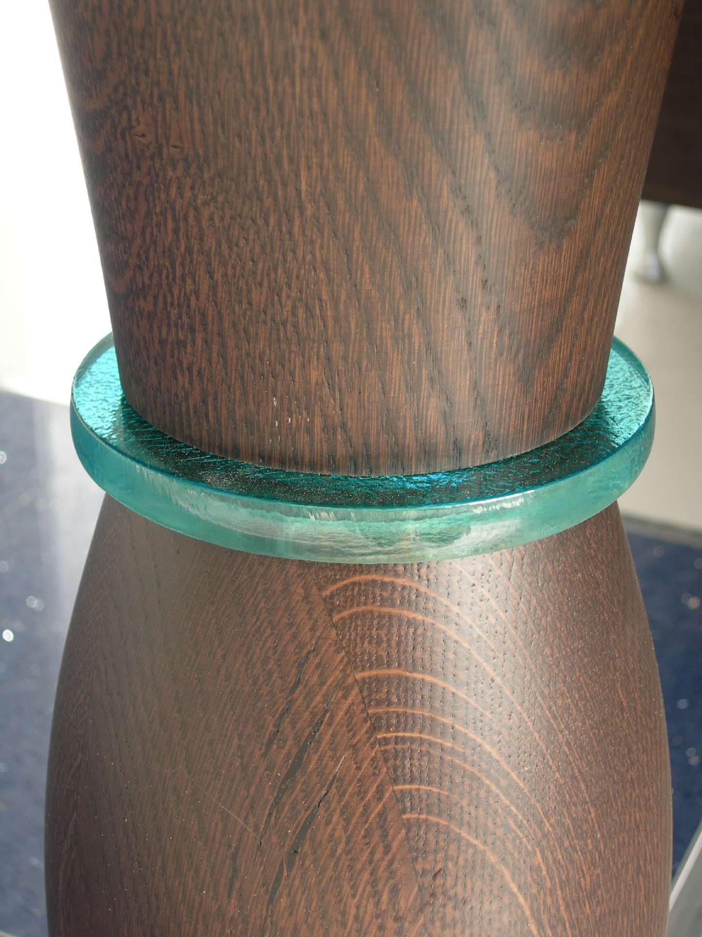 Detail of a timber column with a ring of glass