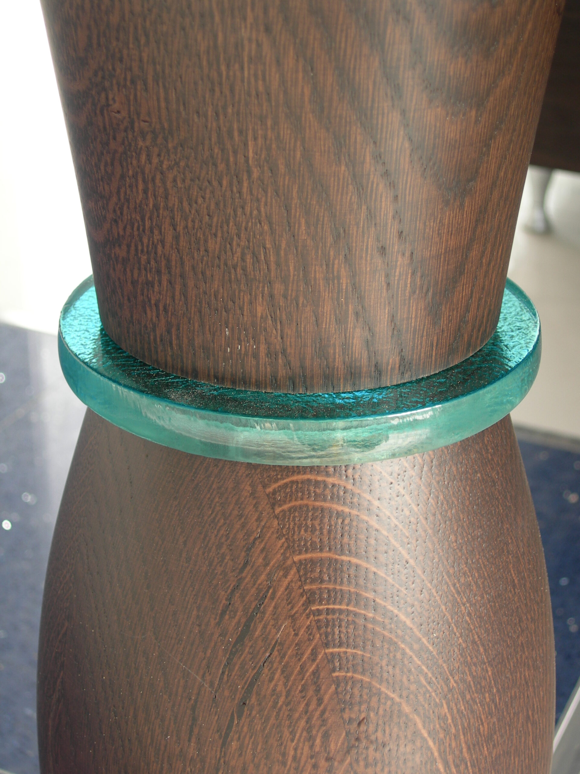 Detail of the timber leg with a ring of glass